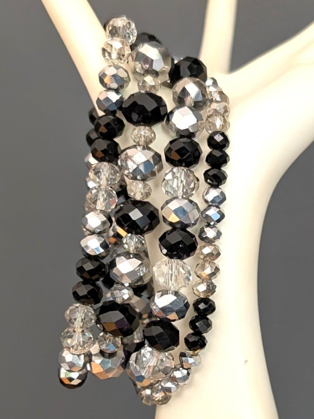 Bundle of black, smoke and mirrored beaded stretch layering bracelets